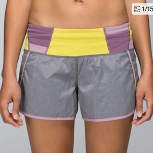 Lululemon Speed Up running shorts in gray with purple and yellow accents. Size 8